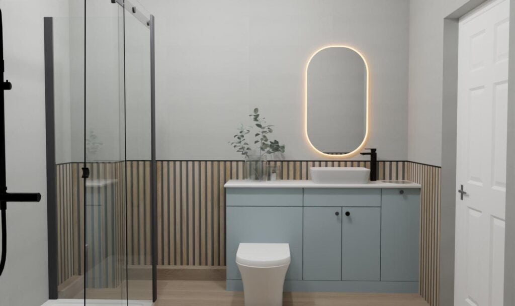 Modern bathroom with a glass shower on the left, a light blue vanity with a vessel basin and black tap, an oval mirror with backlighting, a white toilet, and vertical wood panel accents on the walls.
