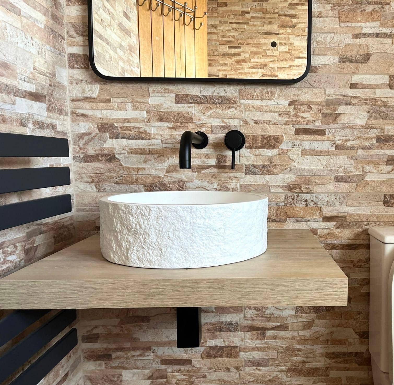 Modern bathroom with a white textured round vessel basin